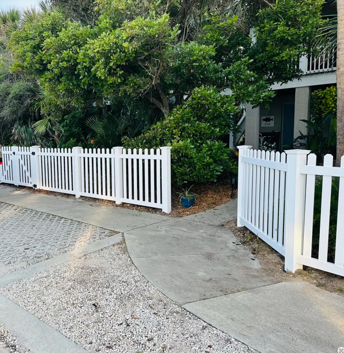 White vinyl picket entry fence