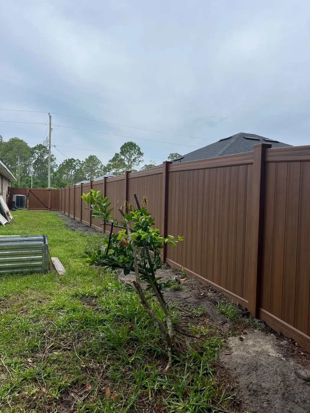 Mocha vinyl privacy fence installation