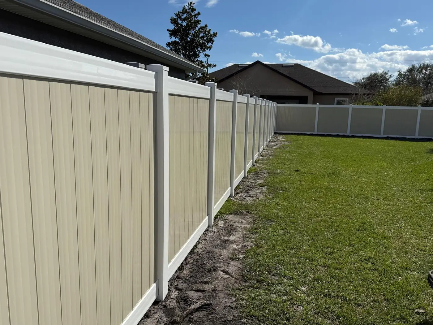 Tan vinyl privacy fence