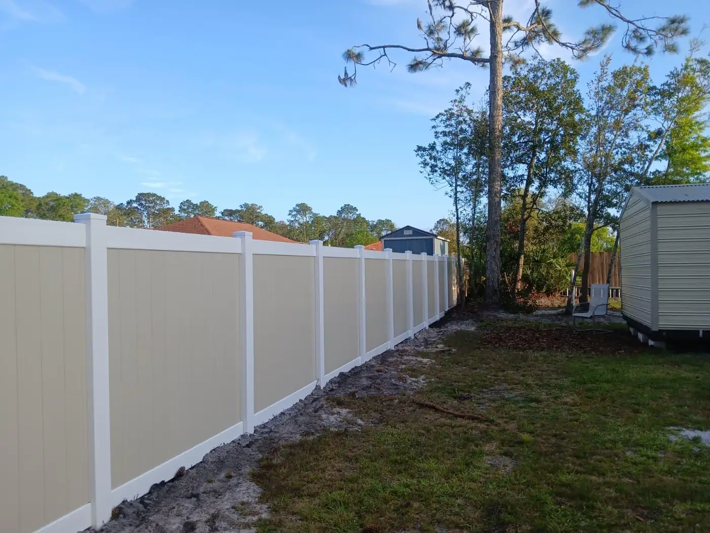 Tan and white vinyl privacy fence