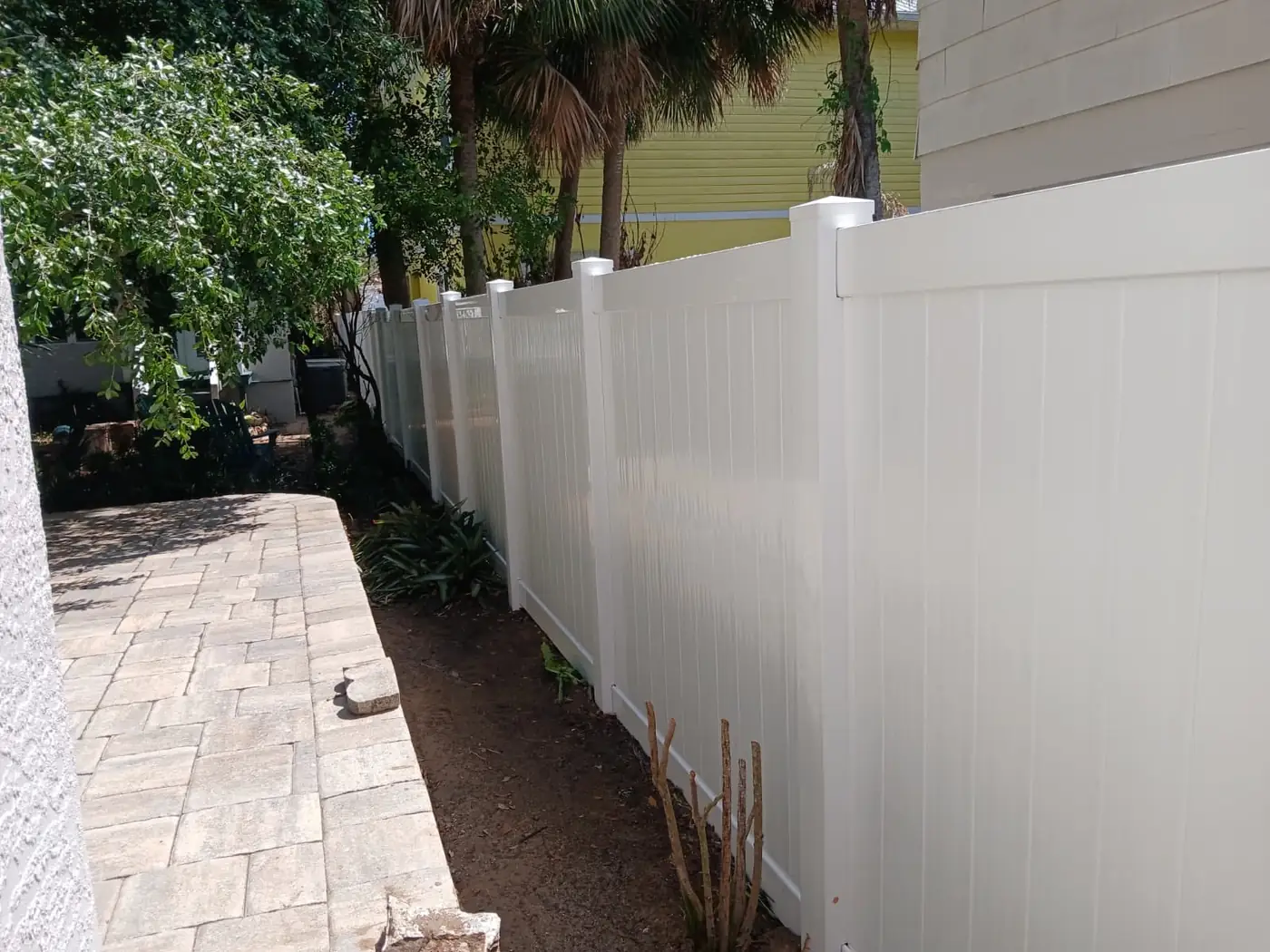 White vinyl fence by pool